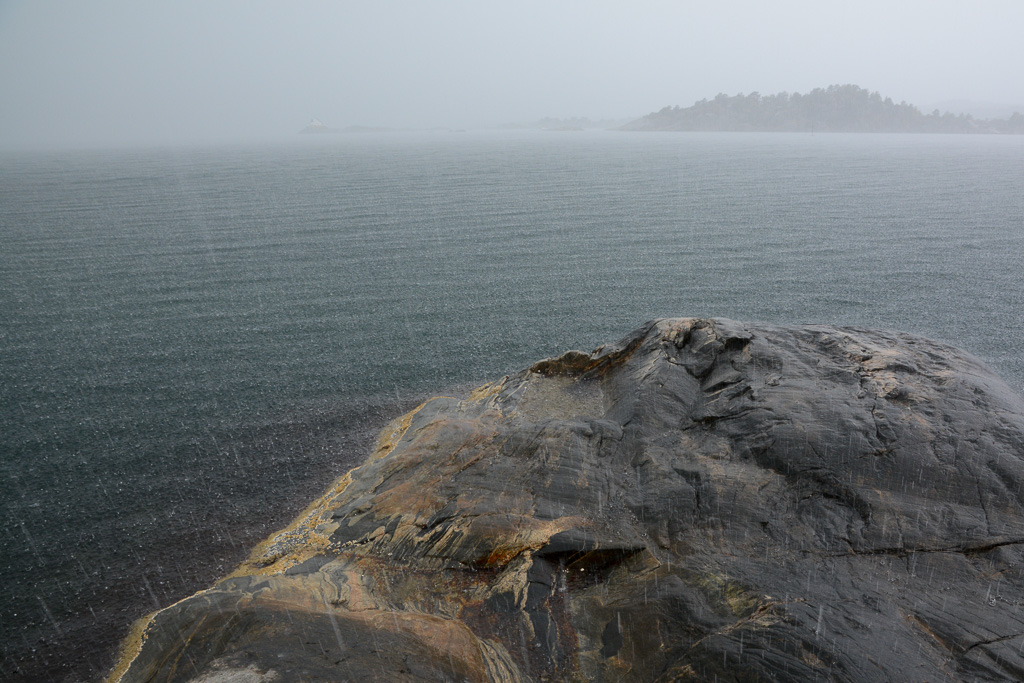 Regn i Lillesand. Saltholmen fyr skimtes i bakgrunnen.